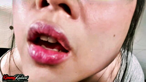 Kimmy Kalani's glossy pink lips and open mouth in seductive ASMR tease