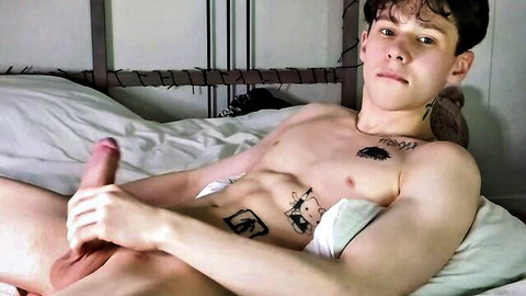 Hot Latin dude with tattoos stroking his big cock on bed in webcam show