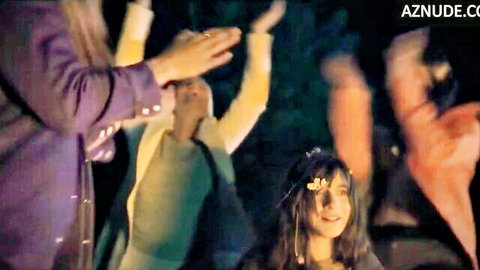 Elena Di Cioccio dancing wildly with friends around campfire on mountain