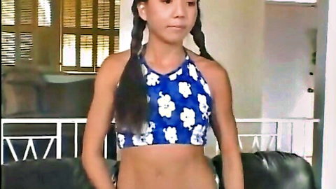 Cute Asian teen with pigtails in blue polka-dot crop top teasing