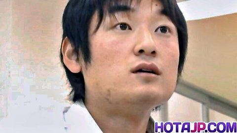 Close-up of young Japanese man in white shirt with parted lips and intense gaze