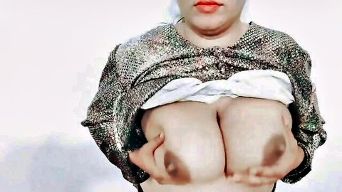 Pakistani BBW MILF in hijab squeezes her massive bare tits together topless