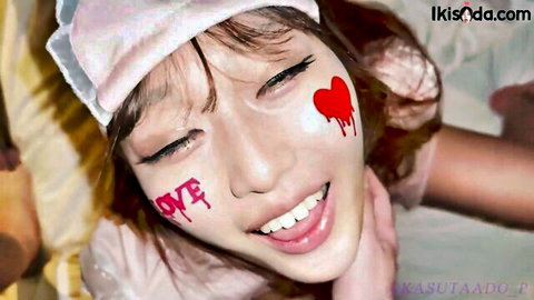 Smiling Asian nurse with sexy LOVE graffiti and dripping red heart on cheek