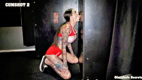 Rocky tattooed brunette deepthroats at gloryhole in red athletic wear, cumshot finish