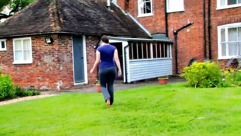 Brunette babe with big juicy ass in tight gray leggings walking barefoot outdoors