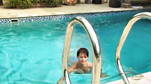 Wet brunette MILF climbs pool ladder in clinging swimsuit showing small tits
