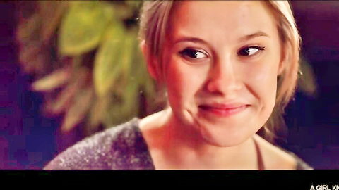 Cute blonde teen smiling seductively close-up in sparkly top