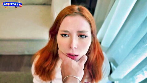 Seductive redhead teacher in white top, touching lips intimately