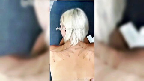 Blonde Italian Paola Calippo topless with wing tattoos during back massage