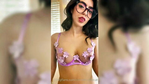 Brunette with glasses teases in sheer purple floral bra exposing perky tits and nipples