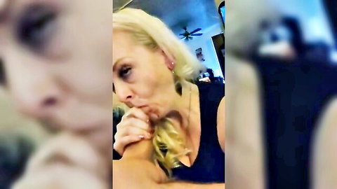Blonde MILF in tank top, seductive thoughtful pose