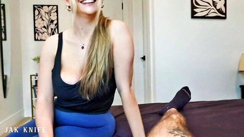 Angie Faith blonde bombshell in tank top showing cleavage on bed