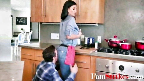 Curvy Latina stepmom in apron bent over for stepson in kitchen