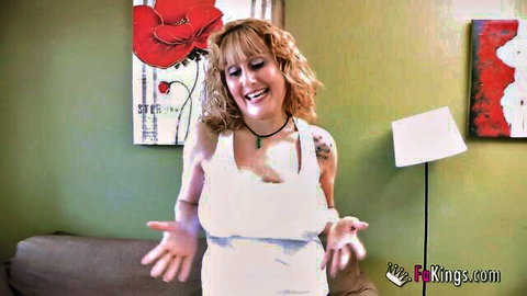 Smiling blonde MILF in white tank top poses playfully for adult video