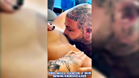 Tattooed muscular man sucking nude woman's big tits passionately