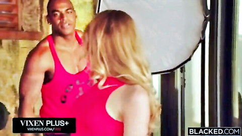 Alexa Flexy blonde in pink top with muscular black stud in studio shoot