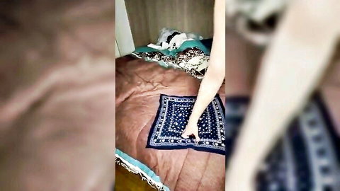 Serena holding cloth over bed in post-sex cleanup from live porno facial