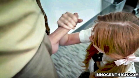 Innocent redhead schoolgirl in uniform held by teacher on stairs