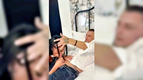 Blurry brunette MILF grabbing tattooed guy's cock bulge through jeans on bed