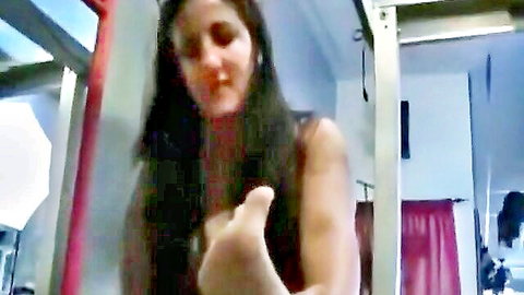 Brunette woman in locker room showing bare foot sole, tickling fetish tease