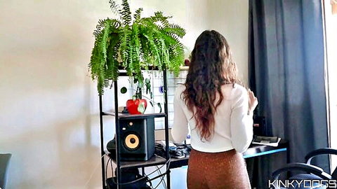 Brunette with big juicy ass in tight brown pants at DJ desk rear view