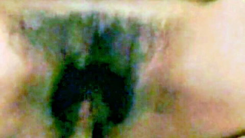 Blurry close-up of mature woman's hairy pussy in taboo mother-son video
