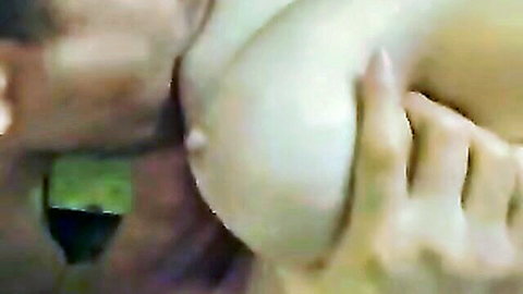 Japanese woman topless with breast squeezed in intimate closeup