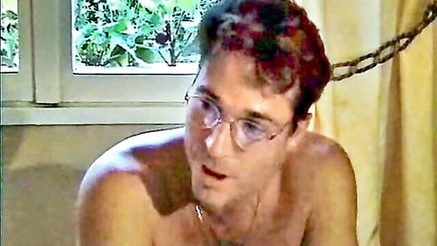 Shirtless man in glasses from French adult movie Putain de Famille