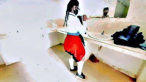 Ebony schoolgirl in red skirt and stockings poses in bathroom with professor