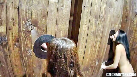 Two Czech brunettes in nude gloryhole gangbang oral action