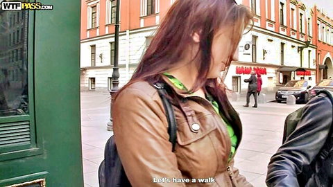 Brunette in leather jacket and green top flirts with guy outdoors before walk