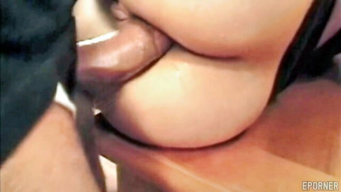 Close-up of woman's plump lips wrapped around thick brown cock in sloppy blowjob.