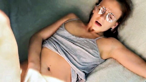 Kate Rich lying seductively in gray tank top, open mouth and stylish glasses