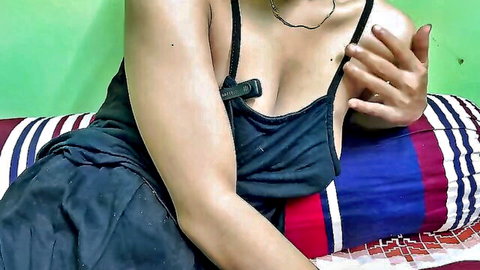 Kaleonjoybd in black top with deep cleavage and necklace