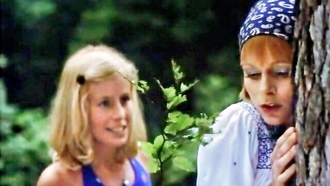 Vintage lesbian thumbnail: playful blonde and redhead women in forest setting