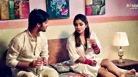 Indian MILF in white outfit chats intimately with handsome man on bed