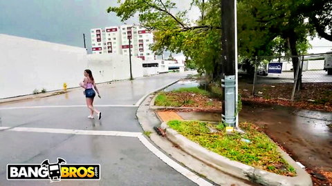 Brunette with big ass struts in tiny shorts across wet public street Bang Bros