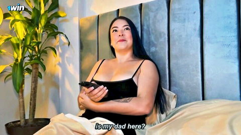 Tattooed curvy Latina with big tits teases deep cleavage on bed asking 'is my dad here?'