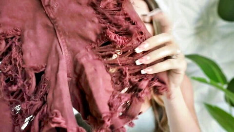 Sexy woman teases by ripping open her tight denim shorts exposing smooth thighs