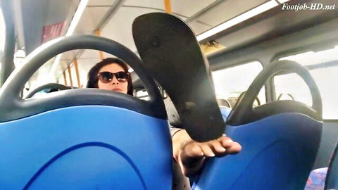 Sunglasses Asian woman teases bare foot sole and flip-flop on public bus