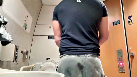 Man exposing ass while peeing in airplane bathroom from behind
