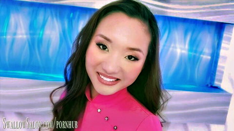 Olea James in pink salon uniform, smiling seductively for steamy blowjob