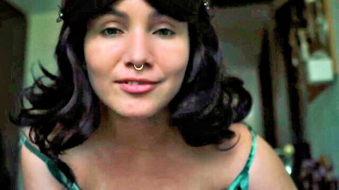 Smiling brunette step-mom with nose piercing in green slip