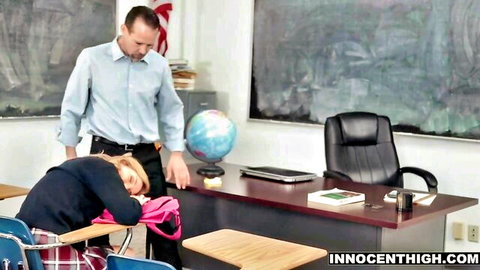 Innocent blonde teen asleep at desk as professor stands behind in classroom