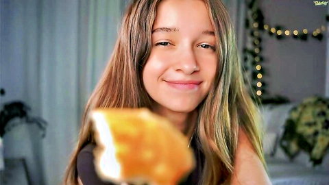 Little Poetry smiles while holding pizza slice on cam, teases before flashing