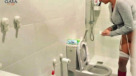 Busty MILF teacher exposes ass while cleaning bathroom, ready to squirt and pee