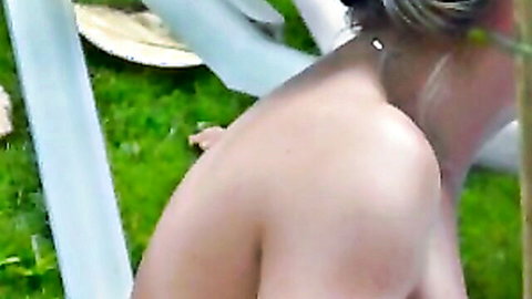 Topless blonde with nice boobs filmed at beach