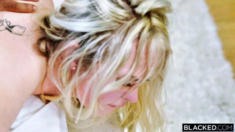 Blonde bombshell Lilly Bell in seductive profile pose with tattoo and necklace