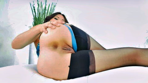 Asian woman in blue top and black stockings exposing pussy and tits