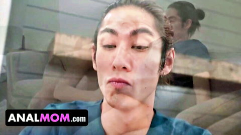 Asian man in blue scrubs grimacing with pleasure on analmom.com